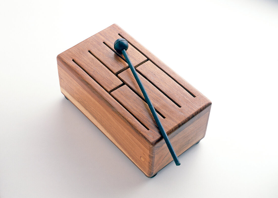 Wooden xylophone with black lace on white background