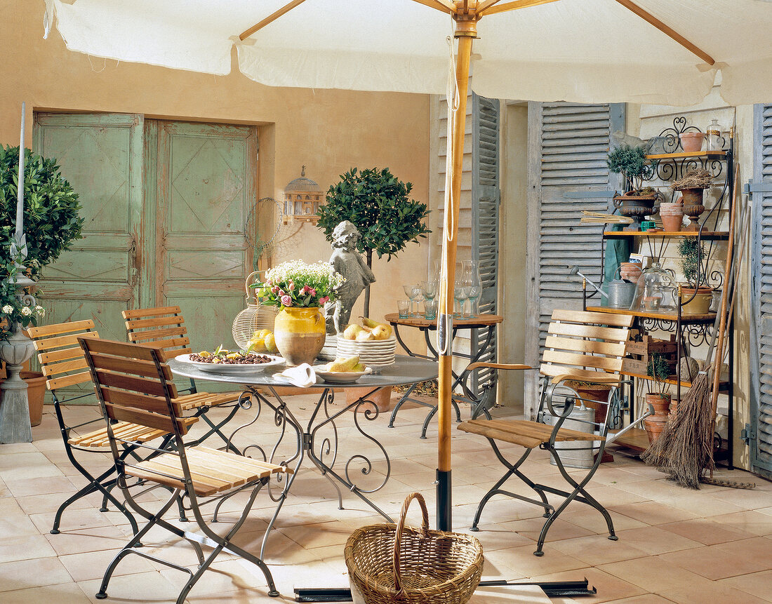 Garden terrace with deck chairs and iron table