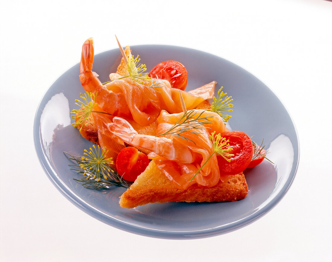 Crab Toast with smoked salmon and tomato on plate