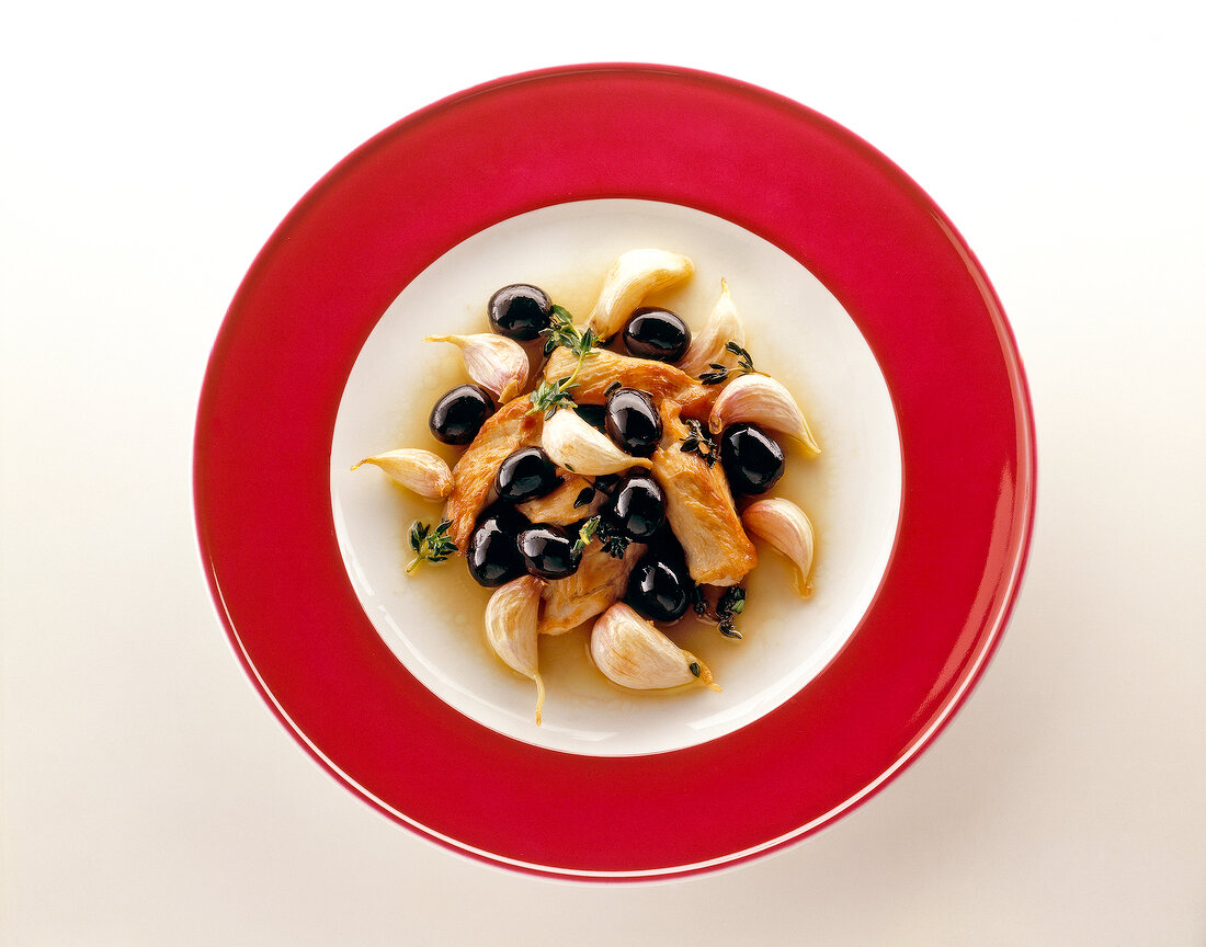 Andalusian chicken with black olives on serving dish