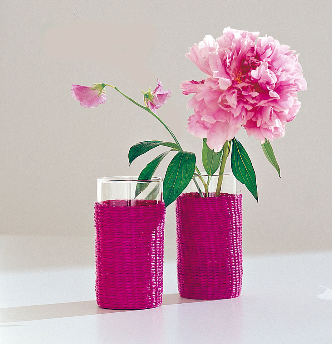 Peony, peony, as decoration in glasses with raffia wickerwork, pink