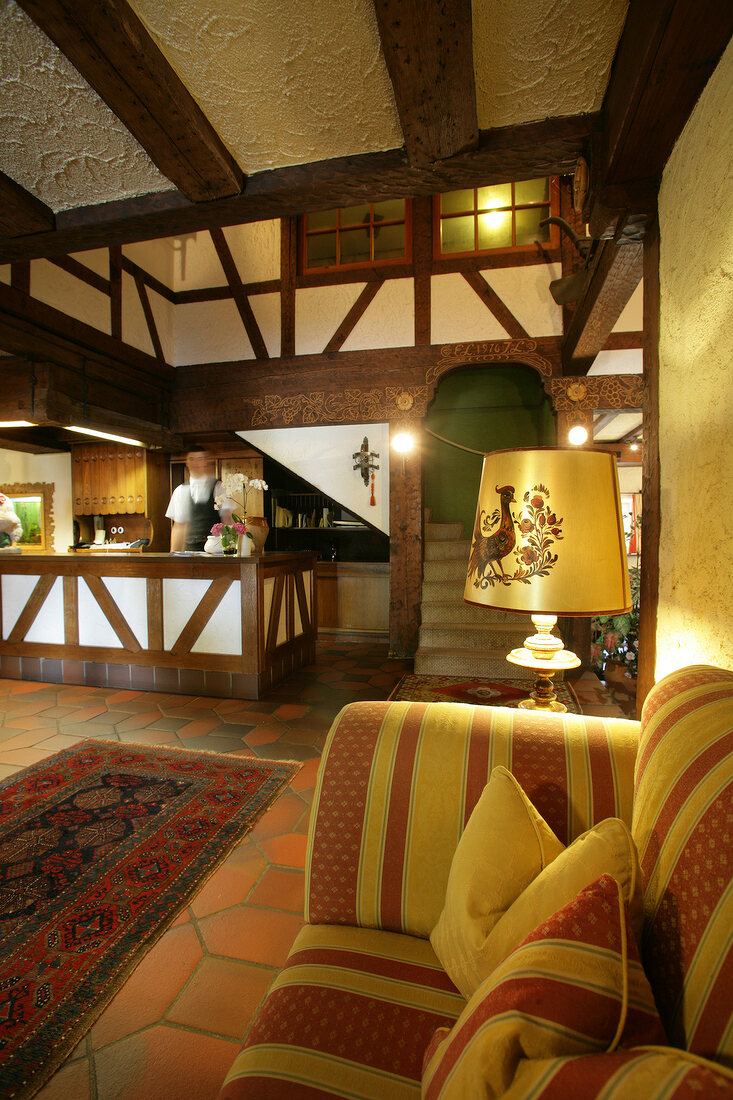 Bar counter, sofa and staircase in hotel, Germany