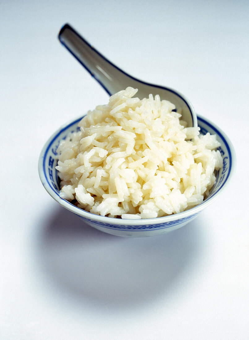 Bowl of rice on white background