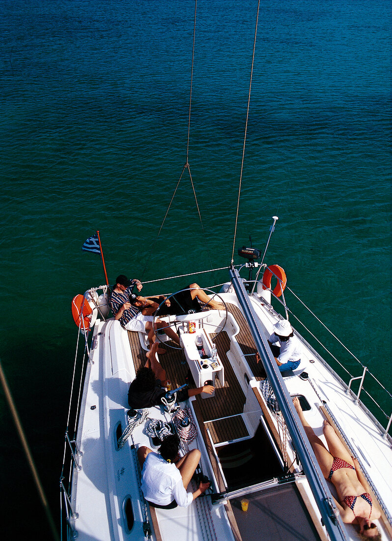 Elevated view of people sunbathing on sail boat