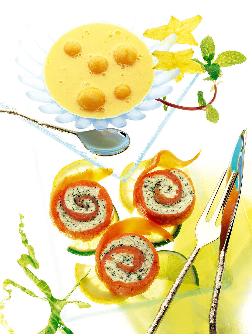 Exotic yoghurt, cold soup, smoked salmon and cream cheese roulade on white background