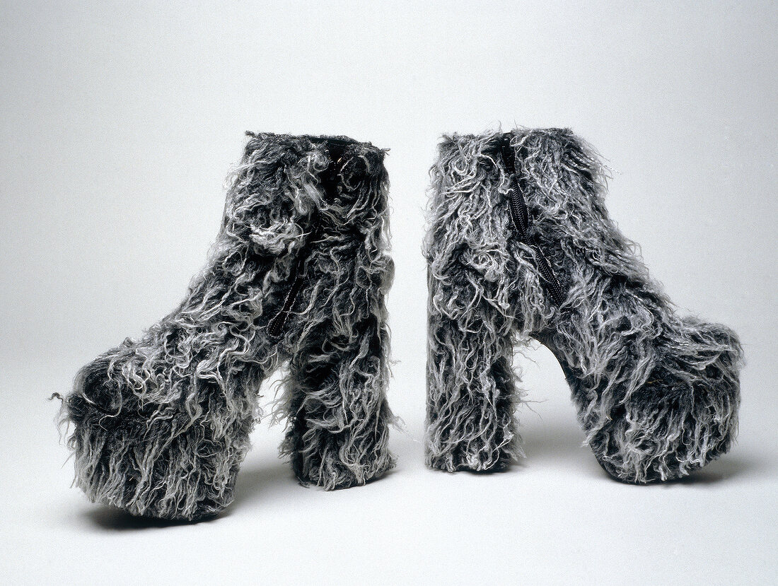 Fur ankle boots with platform heels on white background