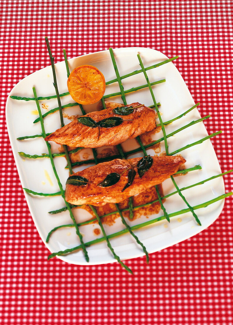 Pork with asparagus grid on plate