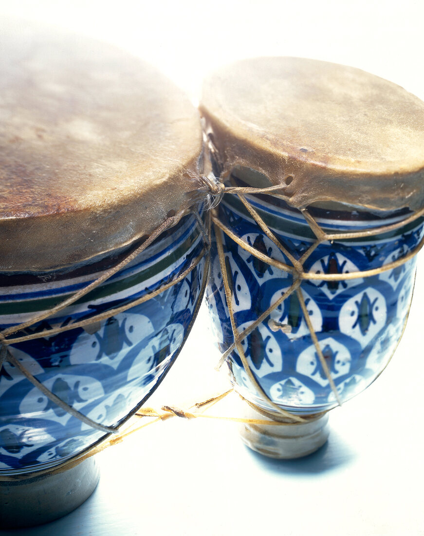Close-up of two blue African drums on white background