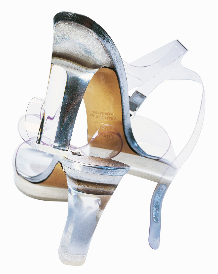 Close-up of transparent high heels on white background
