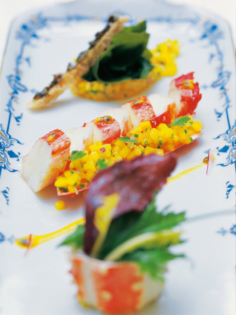 Close-up of crab with mango on plate