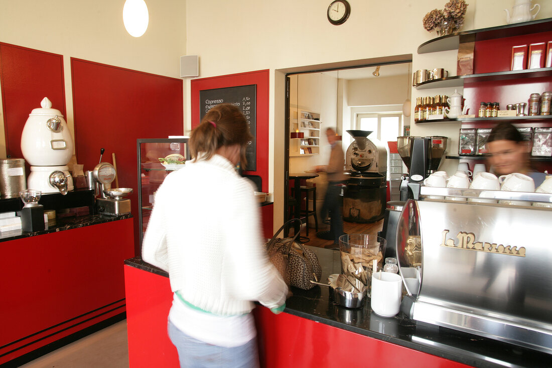 Woman at cafe counter, Germany