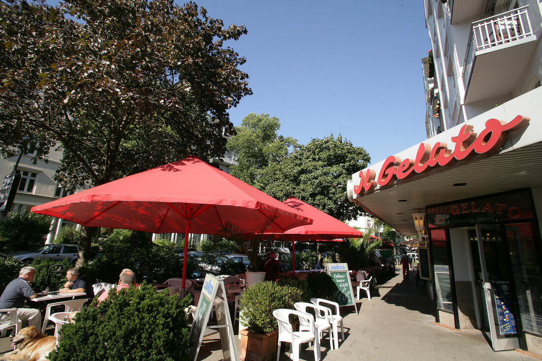 Exterior of ice-cream parlour with parasol, Germany