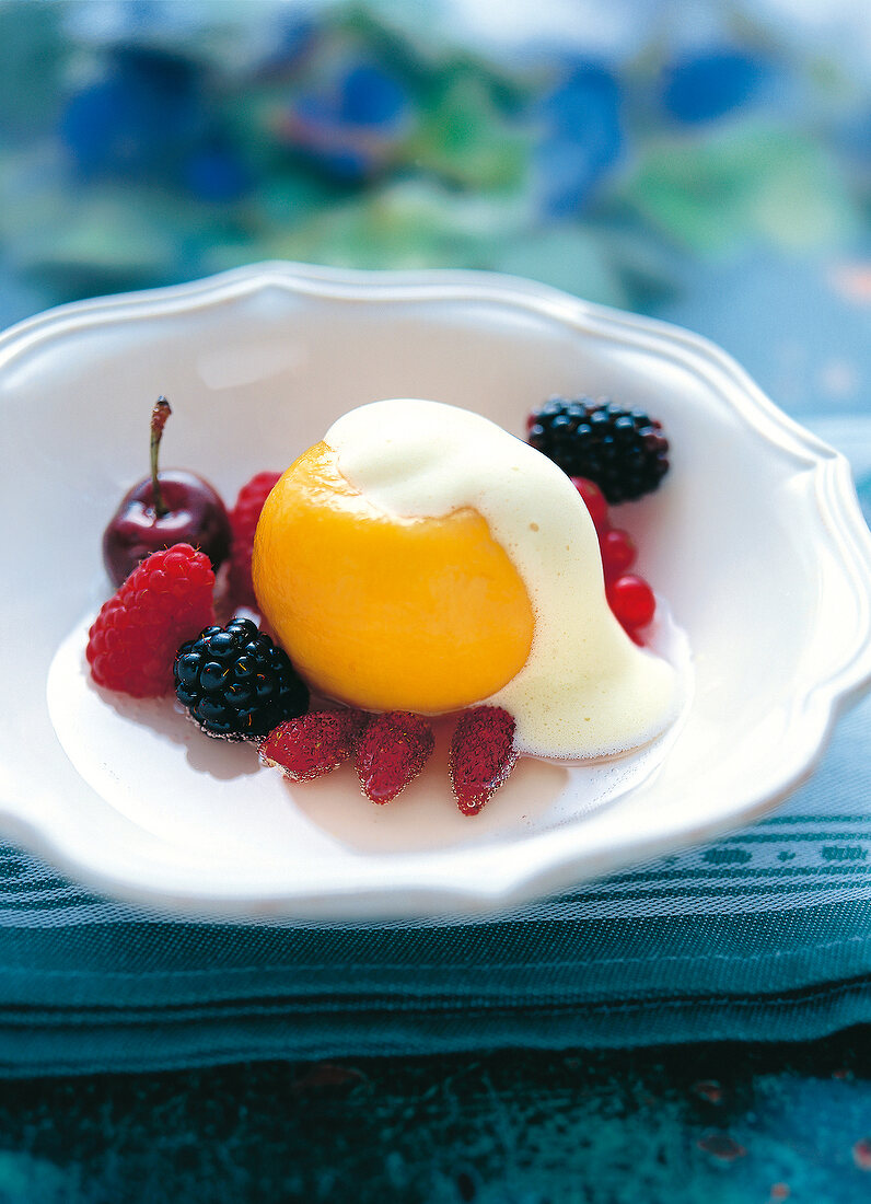 Close-up of dessert with peach, raspberries and cherries on plate