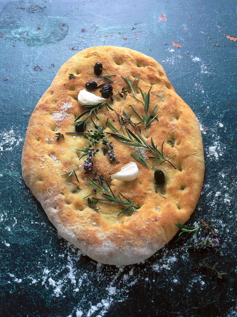 Close-up of Italian flatbread with olive salt and herbs