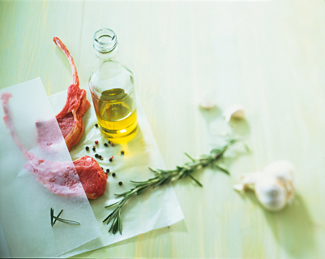 Lamb with raw olive oil and thyme on surface