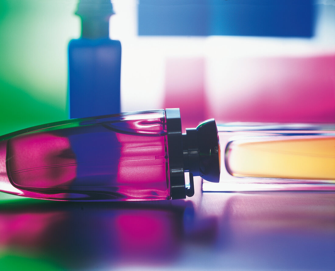 Close-up of different colourful perfume bottles