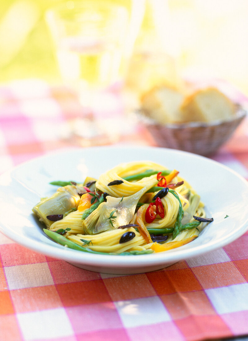 Close-up of tagliatelle with artichokes and wild asparagus on plate