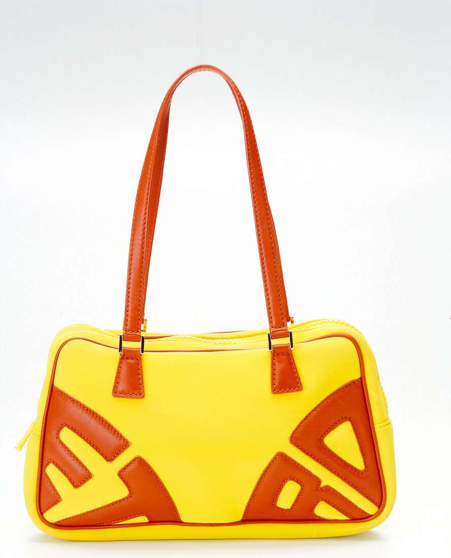 Close-up of red and yellow bowling bag on white background