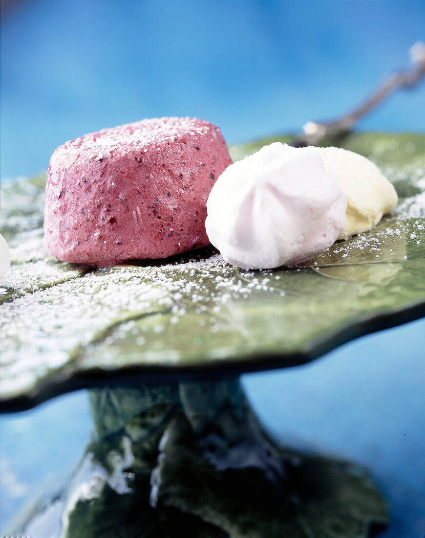 Two meringues with frozen berries yogurt on serving dish