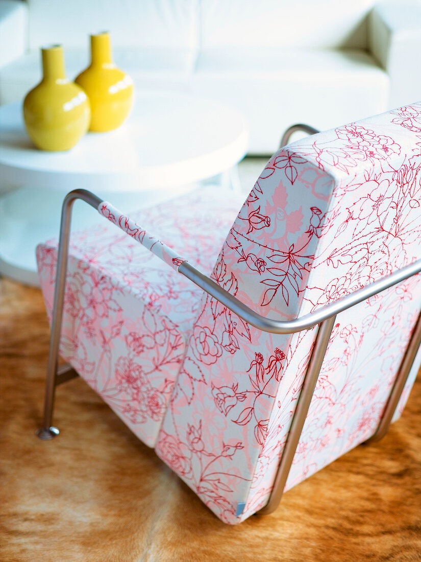 Close-up of chair with stainless steel pipe and floral pattern