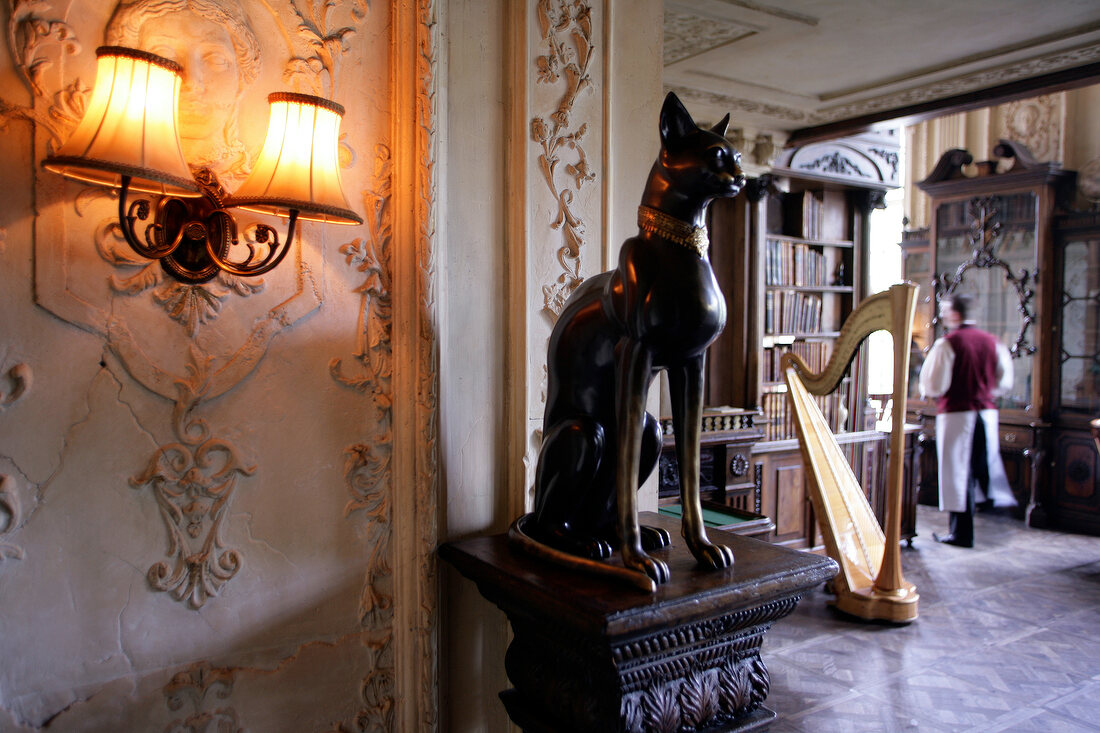Sculpture of dog and waiter standing in Cafe Pushkin in Moscow, Russia