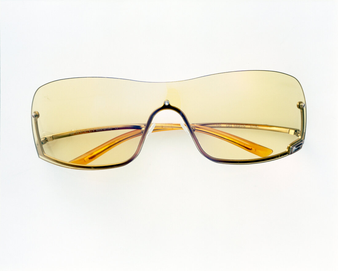 Close-up of yellow sunglasses on white background