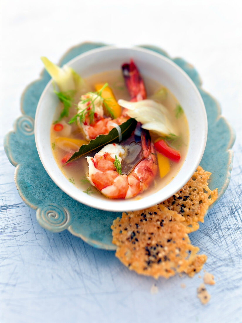 Fennel soup with peppers, king prawns and parmesan in bowl