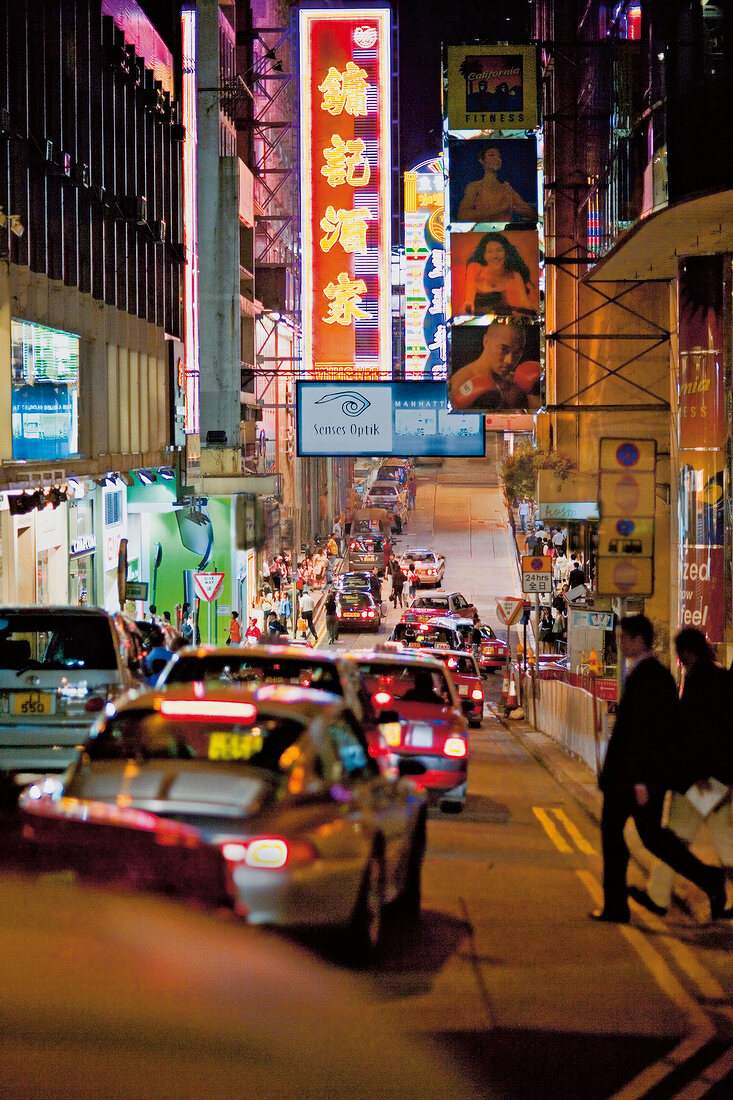 View of busy street of Hong Kong at night with advertising hoardings