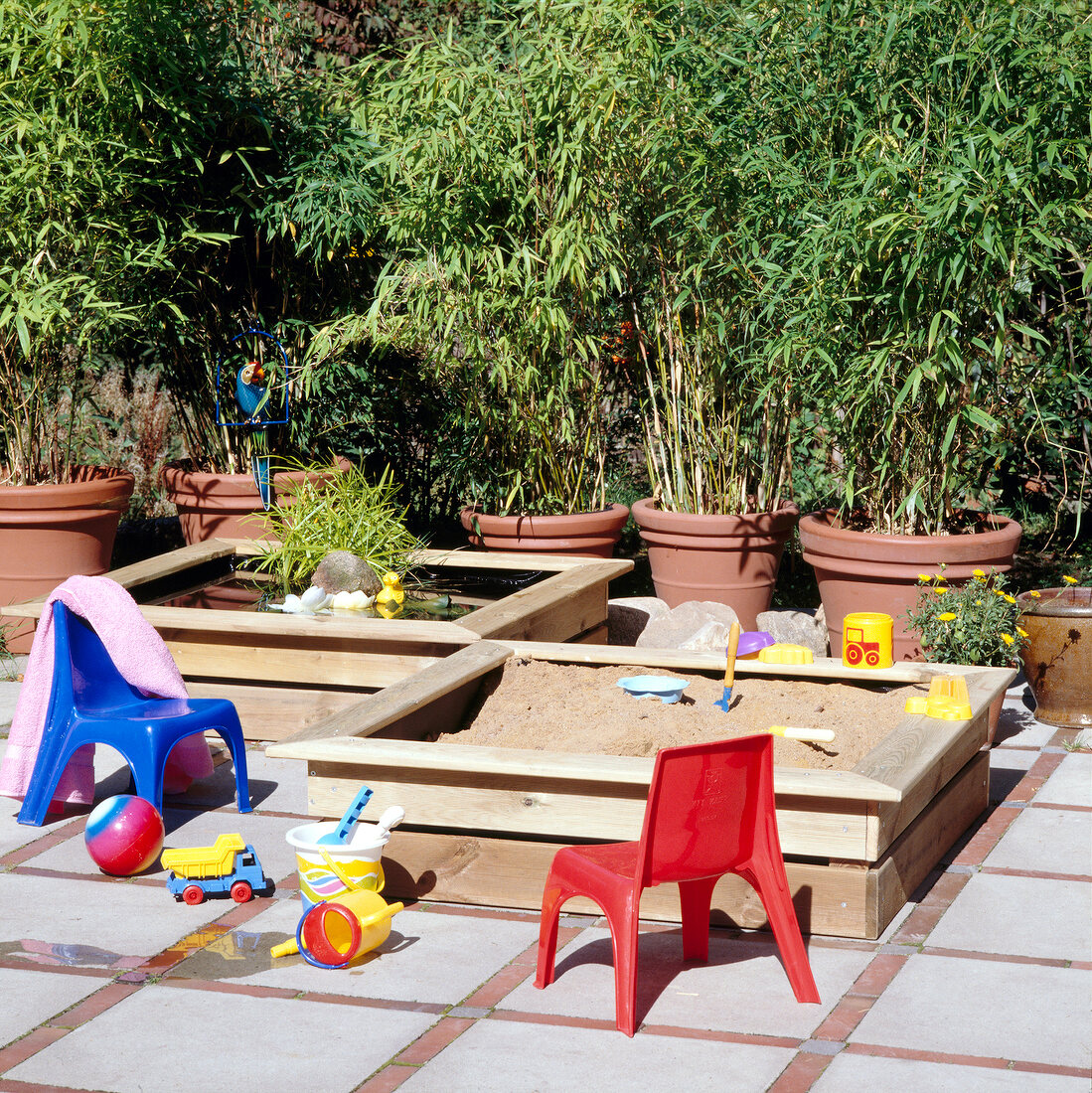 Homemade sandpit and paddling pool in the garden