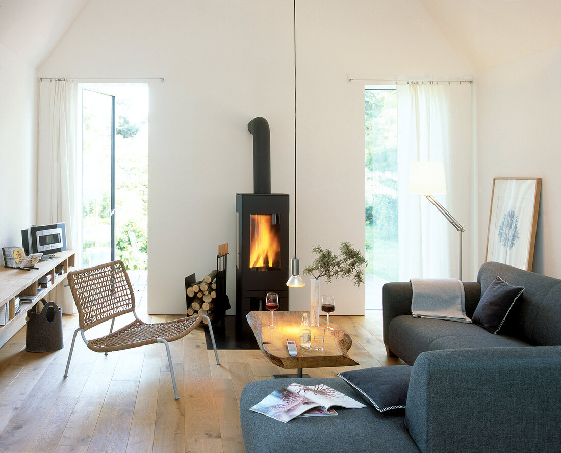 Living room with fireplace, L-shaped sofa and open doors