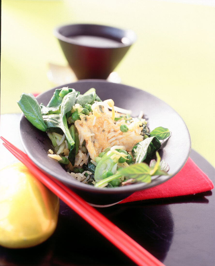 Fried crispy basmati rice with spinach, peas and sprouts in Chinese bowl