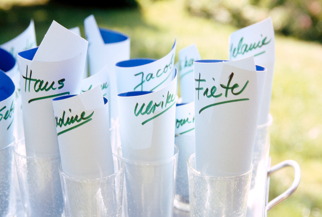 Close-up of name cards in glasses for wildcard