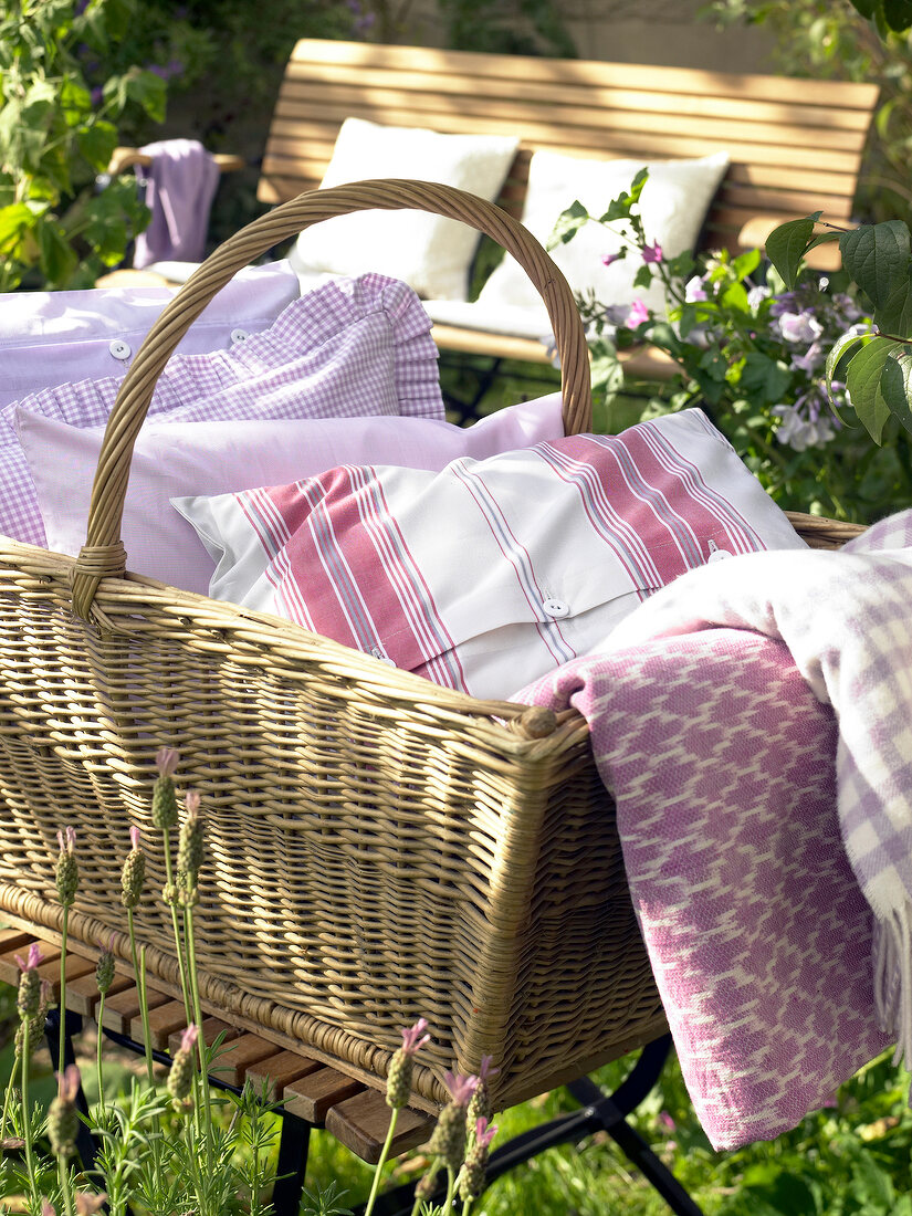 Close-up of basket with pillows in a garden