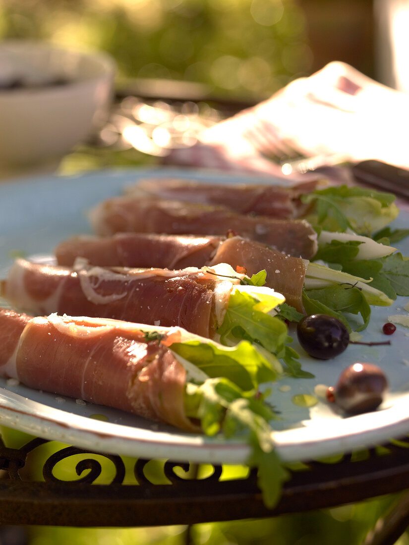 Lettuce salad wrapped in parma ham on plate