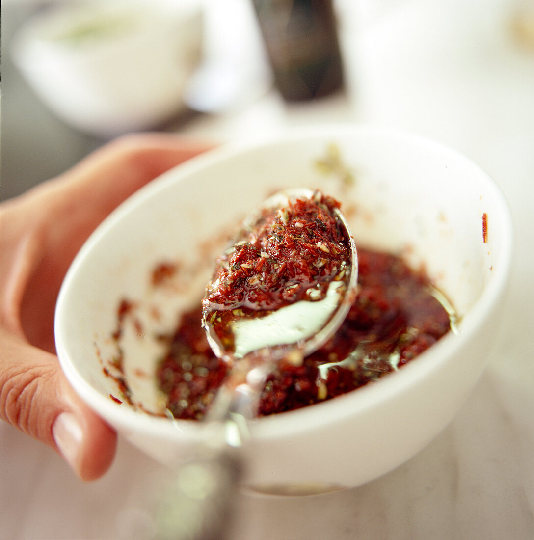 Close-up of spicy dip with spoon in bowl
