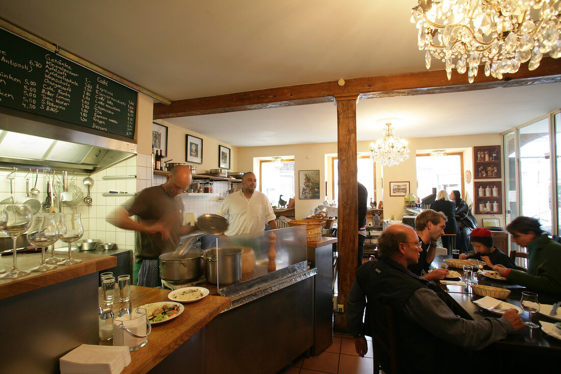 People sitting at table in restaurant, Germany