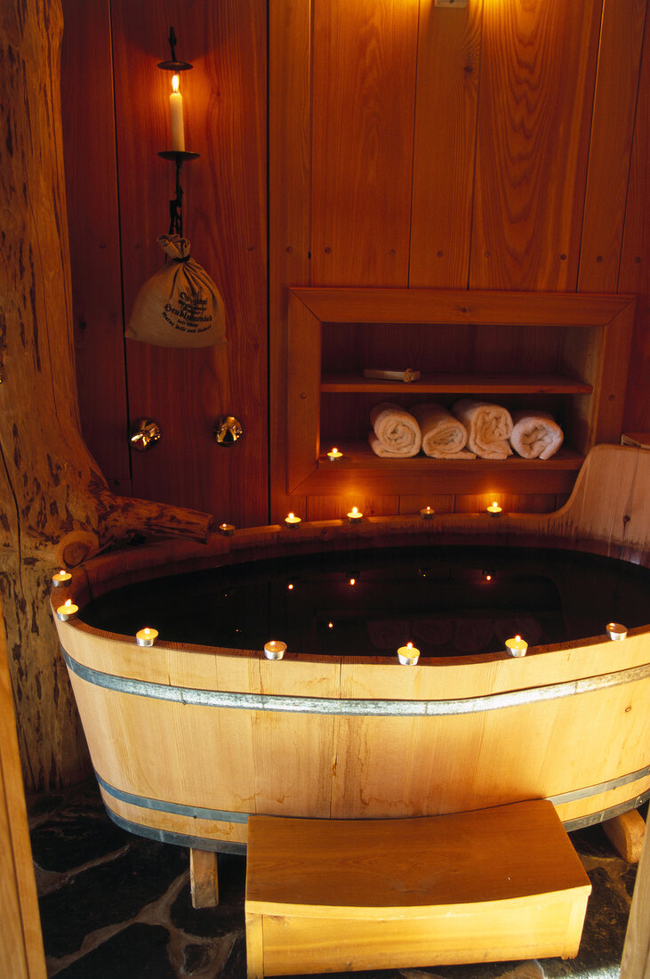 Bathroom with wooden panelled bathtub in a hut in mountain village