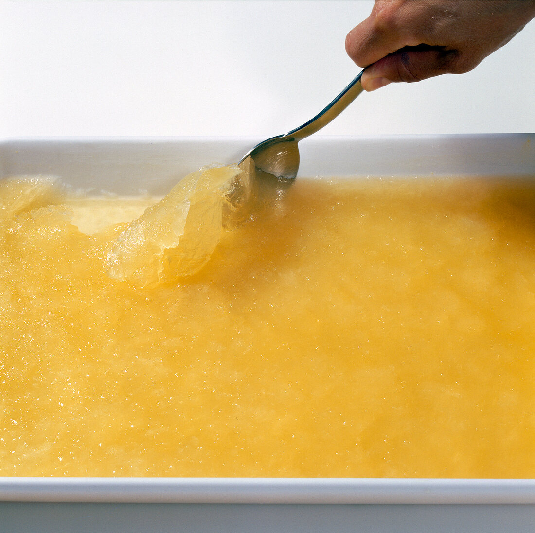 Close-up of frozen lime juice and champagne being scrapped with spoon
