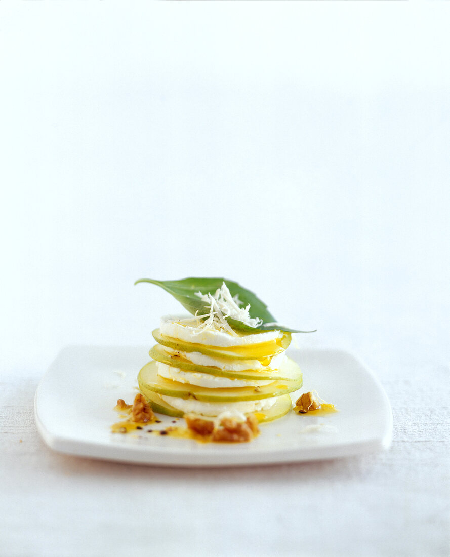 Stacked of sliced apple with yogurt and horseradish dressing on plate