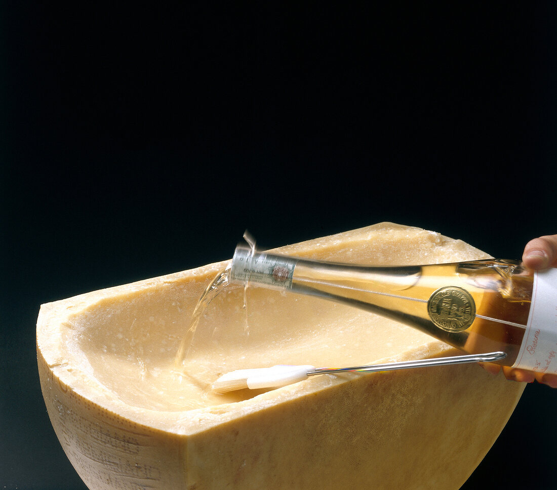 Liquid being poured in parmesan cheese, step 1