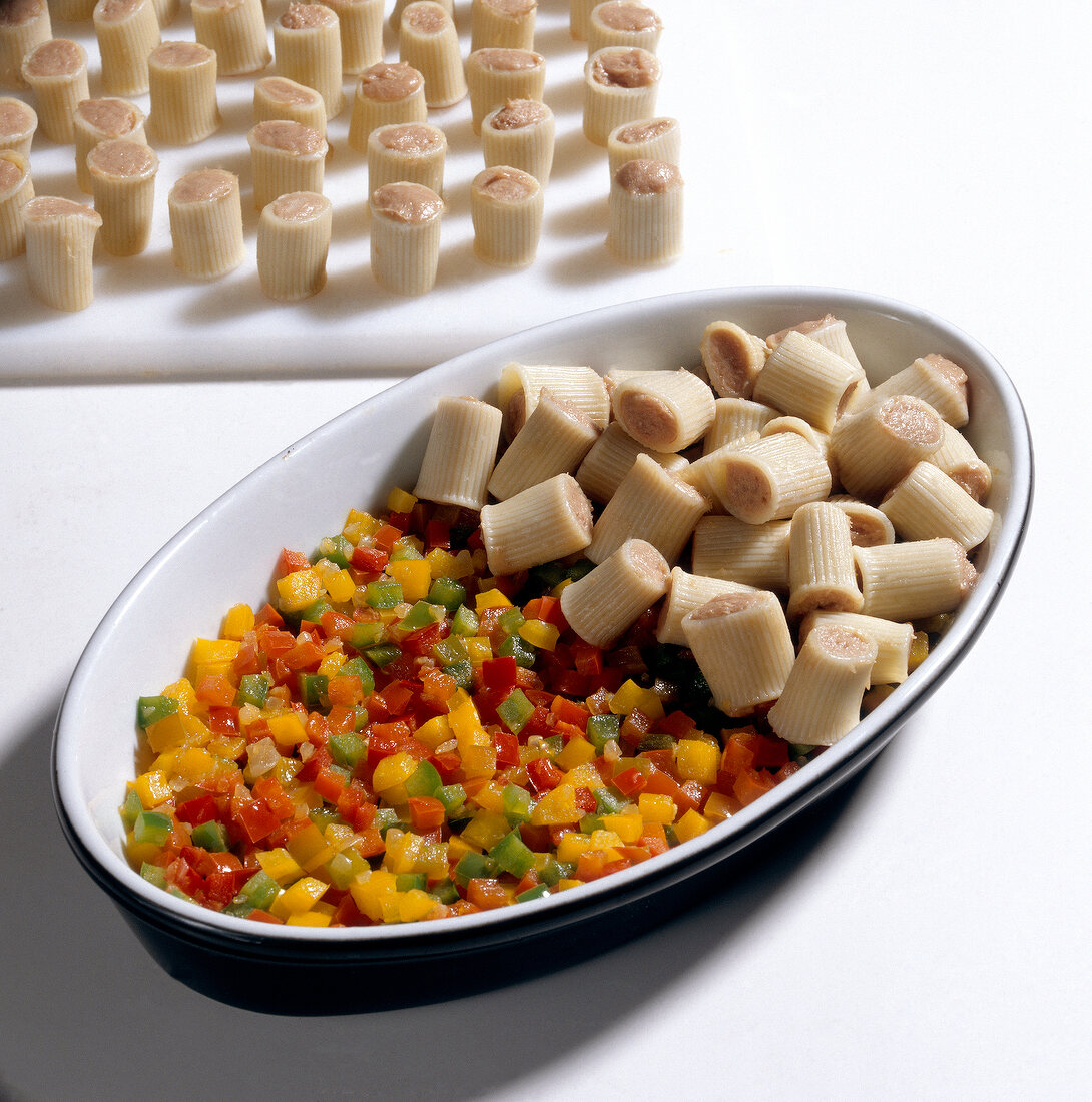 Stuffed pasta with diced peppers on tray, step 1