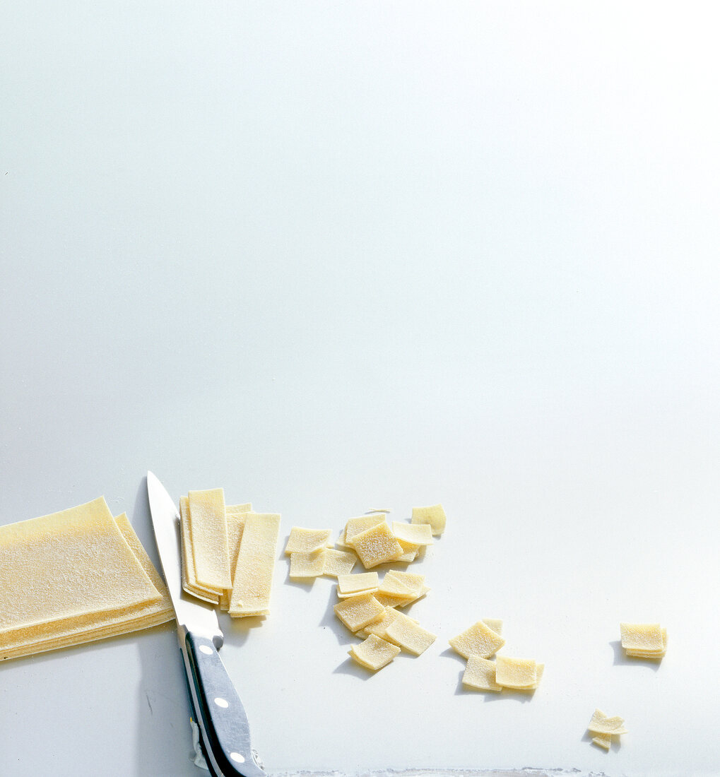 Dough cut into small pieces on white background, copy space