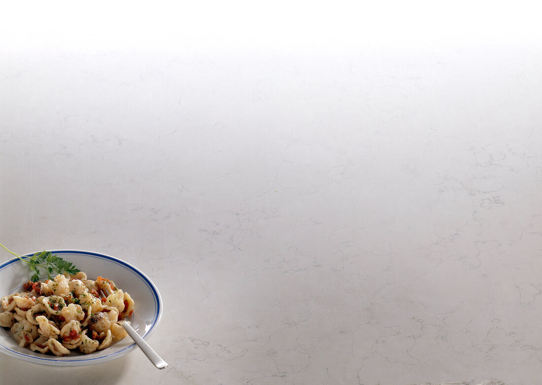 Bowl of orecchiette with cauliflower on white background, copy space