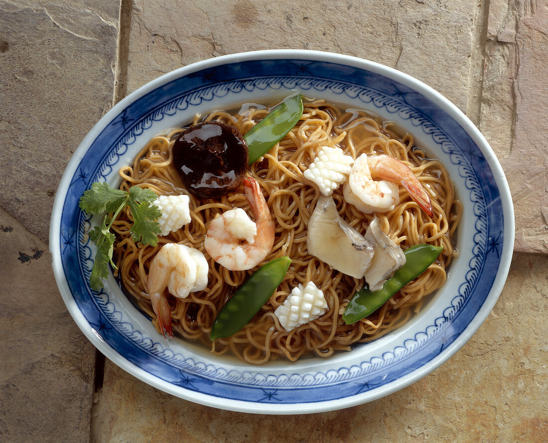 Egg noodles with shrimp on plate