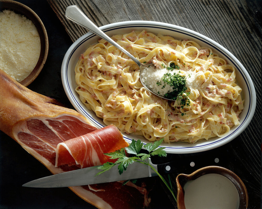 Tagliatelle with ham and cream sauce on plate