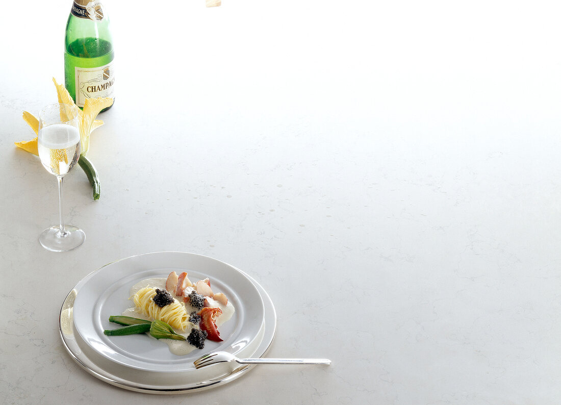 Plate of tajarins with ragout of lobster and champagne on white background, copy space