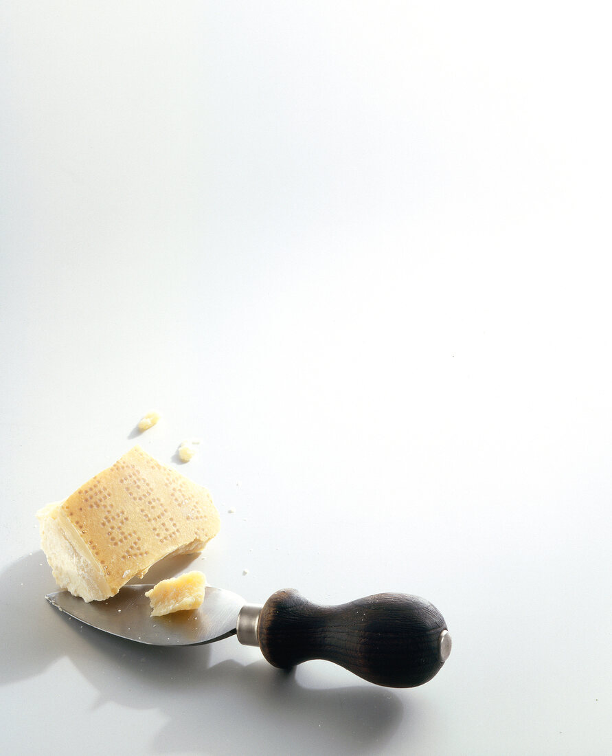 Parmesan with parmesan knife on white background 