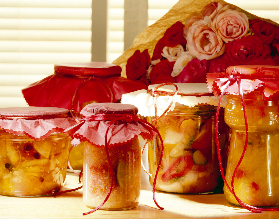 Variety of preserved chutneys in jars tied with cloth