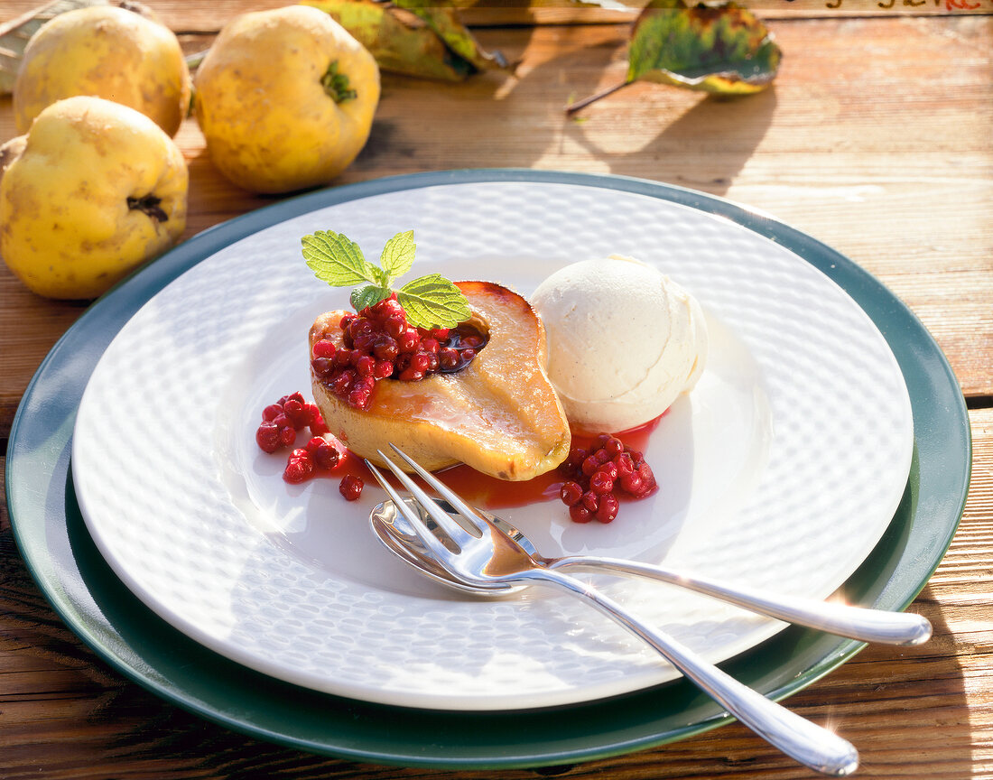 Baked quince with cinnamon ice cream on plate