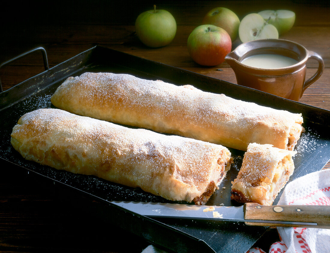 Two apple strudel on baking tray